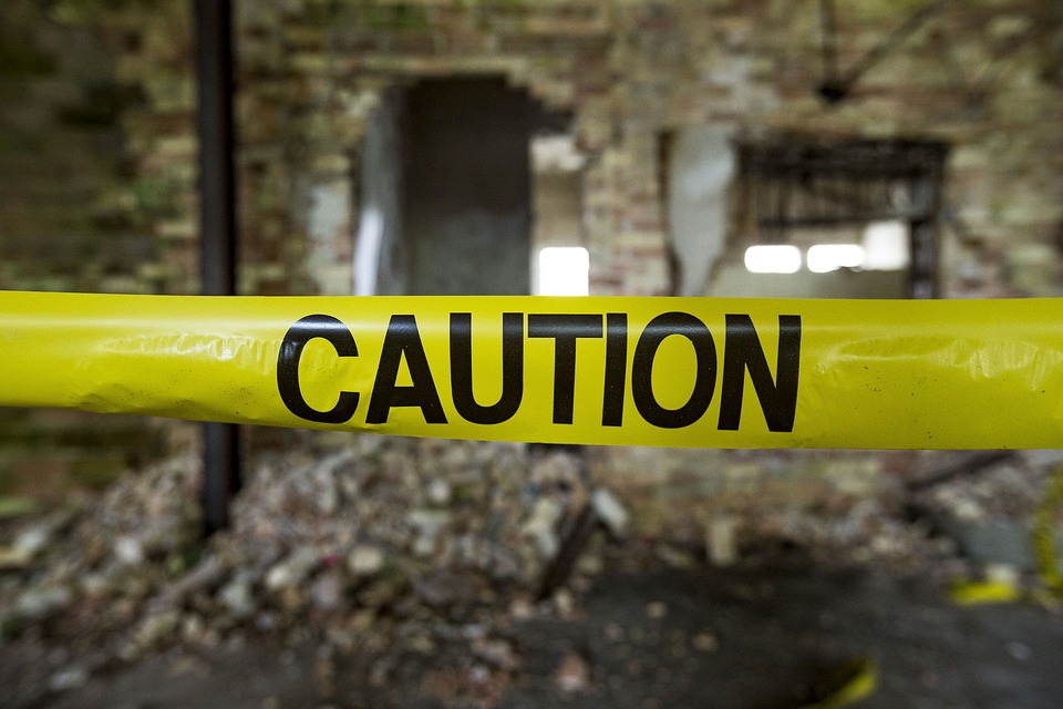 caution tape in front of a demolition site